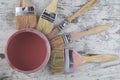 Paintbrushes and paint can in a wood background Royalty Free Stock Photo
