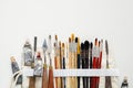 Paintbrushes, palette knifes and paint tubes in textile carry bag. A storage case filled of tools for professional artist work. Royalty Free Stock Photo