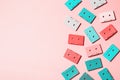 Painted audio cassettes in bright colors and blue earphones on pastel background, copy space, top view. Retro musical background. Royalty Free Stock Photo