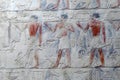 Painted bas relief figures showing daily life in ancient Egypt