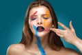 Painted beautiful woman face, artistic make up, body and face art, close up. Facial expression, emotions. Royalty Free Stock Photo