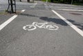 Painted bicycle lane on asphalt in a small town Royalty Free Stock Photo