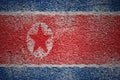 painted big national flag of north korea on a massive old cracked wall Royalty Free Stock Photo