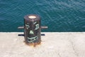 Painted black bollard with smiling face