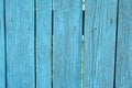 Painted blue old faded wooden planking background with flaws