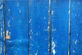 Painted blue wood fence with charred paint