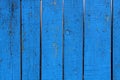 Painted blue wood fence with charred paint