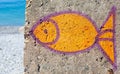 Painted bright fish on a concrete wall - street art, graffiti