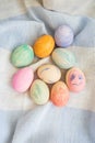 Painted bright and multi-colored Easter eggs on the background of a linen tablecloth, eggs painted with watercolors Royalty Free Stock Photo