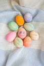 Painted bright and multi-colored Easter eggs on the background of a linen tablecloth, eggs painted with watercolors Royalty Free Stock Photo