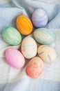 Painted bright and multi-colored Easter eggs on the background of a linen tablecloth, eggs painted with watercolors. Cute face in Royalty Free Stock Photo