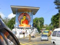 Painted Buddha statue at road junction