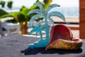 Painted Carved palm tree with heart nut shell and ocean background Royalty Free Stock Photo