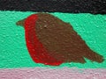 A painted robin on a wall with green black and pink background Royalty Free Stock Photo