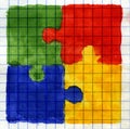 Painted colored puzzle pieces on math paper.