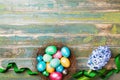 Painted colorful Easter eggs in nest with hyacinth flowers and ribbon top view. Festive background for spring holiday. Royalty Free Stock Photo