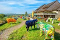 Painted colorful sculptures of cows in Motel de la Gruyere near lake of Gruyere. Switzerland