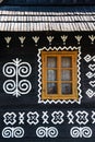 Painted decorations on wall of log house in Cicmany, Slovakia