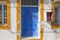 Painted door of an abandoned workshop in Pyrgos, Santorini, Greece.