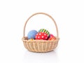 Painted Easter eggs in the basket on white background. Royalty Free Stock Photo