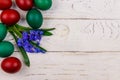 Painted Easter eggs and blue scilla flowers on white wooden background. Easter composition. Top view, copy space Royalty Free Stock Photo