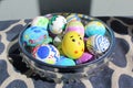 Painted Easter eggs in a fancy glass bowl in sunshine