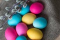 Painted Easter eggs lie on a natural matting along with willow branches. The concept of celebrating Easter