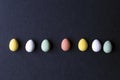 painted Easter Eggs various colors on black background, top view modern design Royalty Free Stock Photo