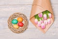 Painted eggs in nest. Spring holiday. Holiday celebration, preparation. Happy easter. Tulip flower bouquet. Healthy and