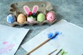Painted eggs and one egg decorated with bunny ears, diy easter eggs concept Royalty Free Stock Photo