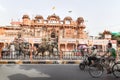 Painted elephants for the Holi Elephant festival riding through the busy traffic along a construction site of the city in Jaipur, Royalty Free Stock Photo