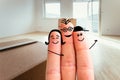 Family moving into a new home concept: Painted finger family in front of blurry bright room