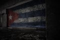 Painted flag of cuba on the dirty old wall in an abandoned ruined house Royalty Free Stock Photo