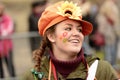 Painted flowers on cheek of nice dressed up woman at Carnival pa