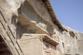 Caves cut into cliff face with boardwalk and stairs at Mogao Grottoes, Dunhuang, Ganzu, China