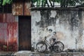 Painted Girl and Boy Riding Real Bicycle on The Old Concrete Wall from The Street of George Town. Penang, Malaysia