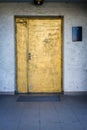 Painted in gold door with a blue white wall Royalty Free Stock Photo