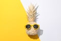 Painted gold pineapple with sunglasses on two tone background. Painted gold pineapple with sunglasses on two tone Royalty Free Stock Photo