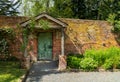 Painted green door and porch in walled garden wall