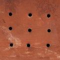 Painted grungy metal surface with holes Royalty Free Stock Photo