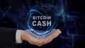 Painted hand shows concept hologram Bitcoin cash on his hand