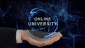 Painted hand shows concept hologram Online university on his hand Royalty Free Stock Photo