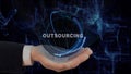 Painted hand shows concept hologram Outsourcing on his hand Royalty Free Stock Photo