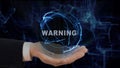 Painted hand shows concept hologram Warning on his hand Royalty Free Stock Photo