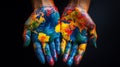Painted hands displaying a colorful world map on a dark background image Royalty Free Stock Photo