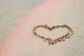 A painted heart on pink sand. Symbol of love Royalty Free Stock Photo