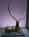Painted lacquer reclining deer with antlers