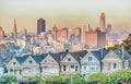 Painted Ladies Victorian houses in Alamo Square and a view of the San Francisco skyline and skyscrapers. Photo processed in pastel Royalty Free Stock Photo