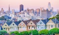 Painted Ladies Victorian houses in Alamo Square and a view of the San Francisco skyline and skyscrapers. Photo processed in pastel