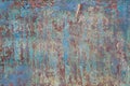 Close-up of a metal or steel plate, covered with old paint. Cracking and flaking paint on rusty iron background. Royalty Free Stock Photo